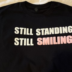 Gildan Heavy Cotton Black Tee M/L “Still Standing Still Smiling”